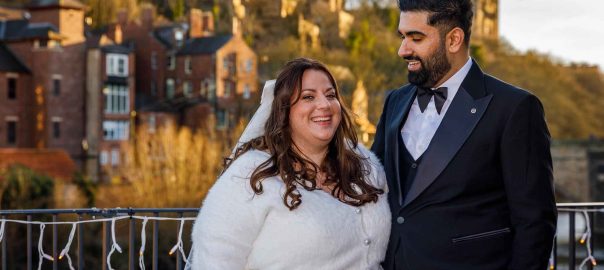 Bride & Groom posing in front of Durham Castle and Durham Cathedral
